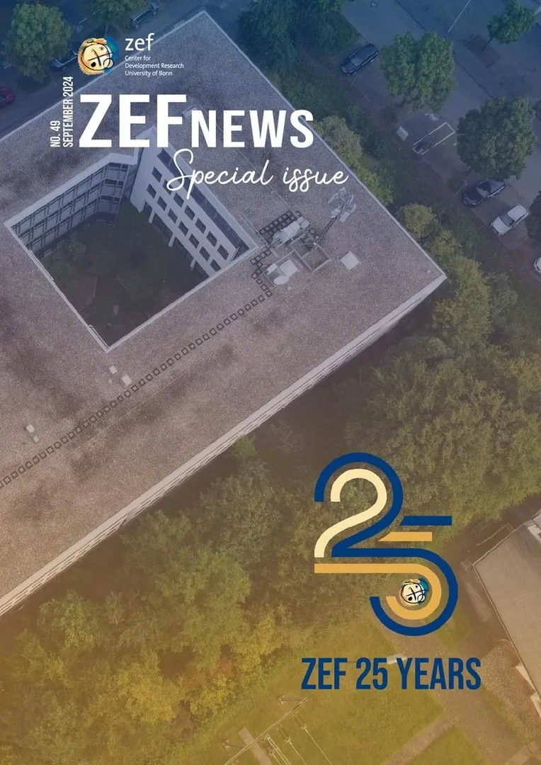 Eine Wissenschaftlerin und ein Wissenschaftler arbeiten hinter einer Glasfassade und mischen Chemikalien mit Großgeräten.