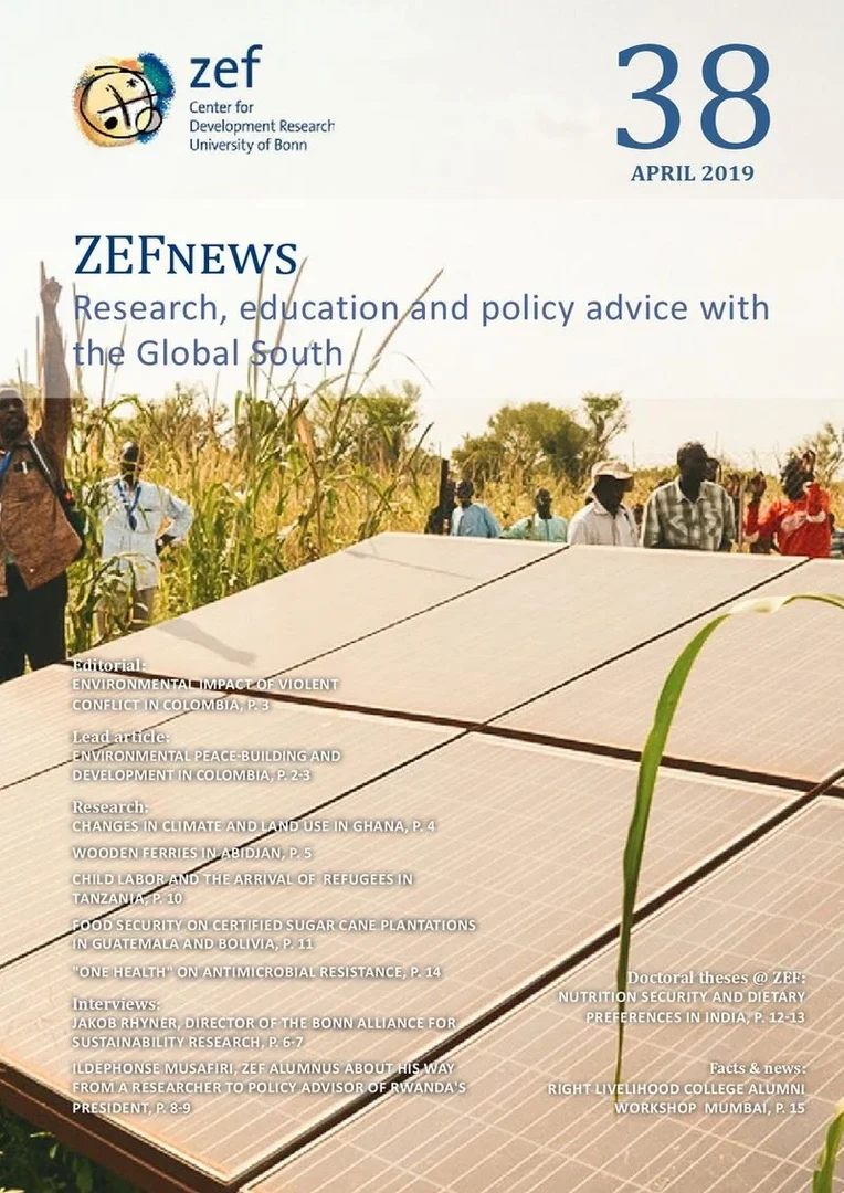 Eine Wissenschaftlerin und ein Wissenschaftler arbeiten hinter einer Glasfassade und mischen Chemikalien mit Großgeräten.