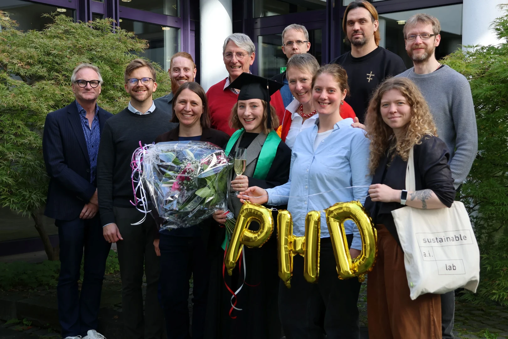 Sophia Falk at her graduation celebration at ZEF with friends, family and supervisors