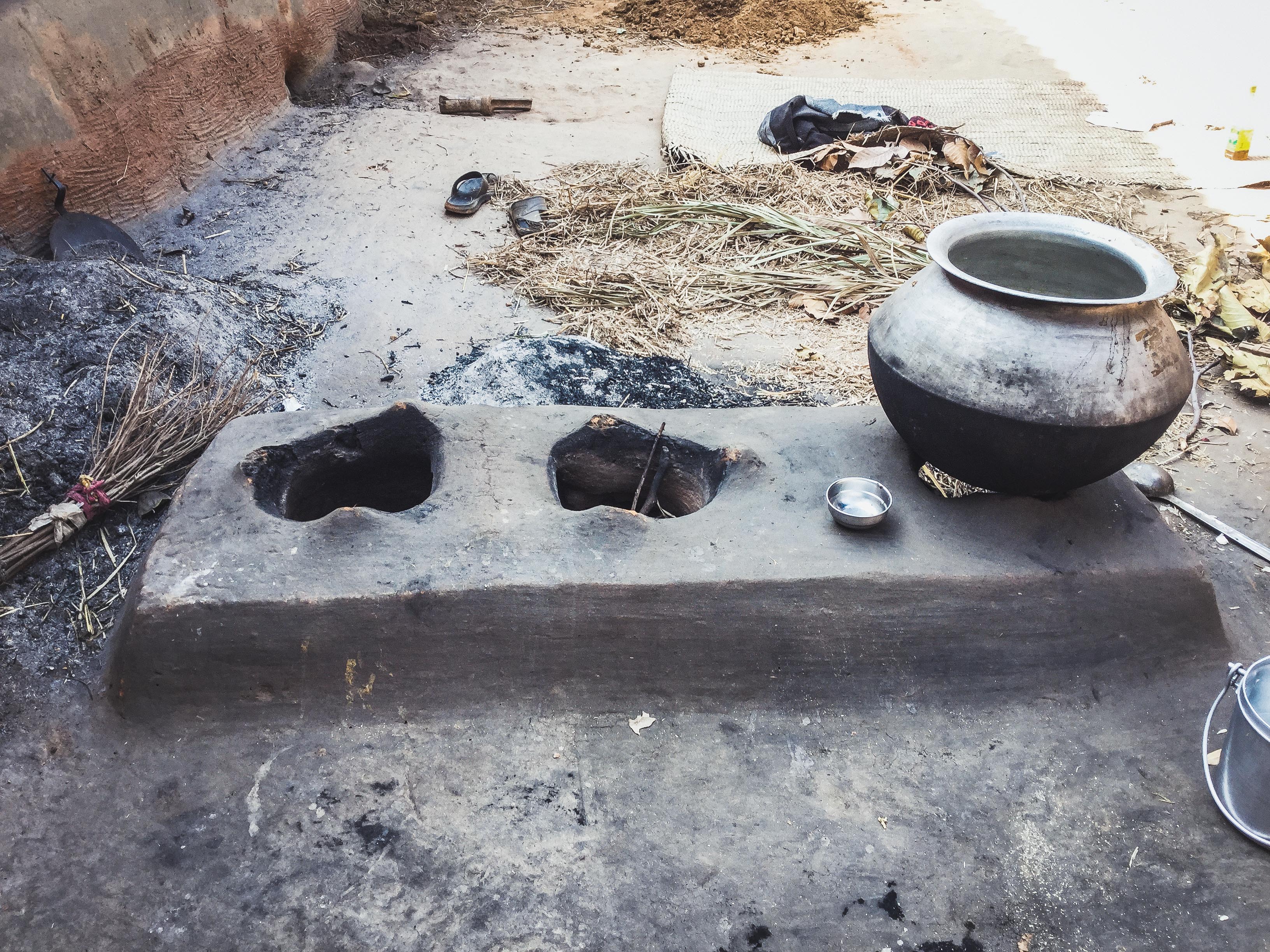Kitchen space with three ovens in mud-made facility, Jhargram, India.